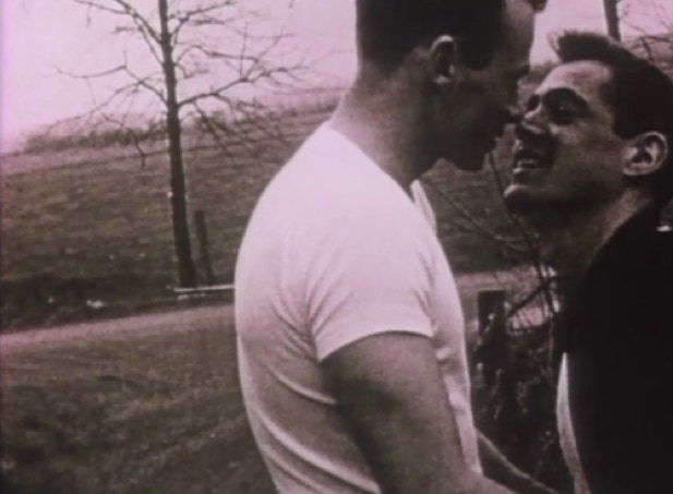 Two young men about to kiss, perhaps in the 1950s.
